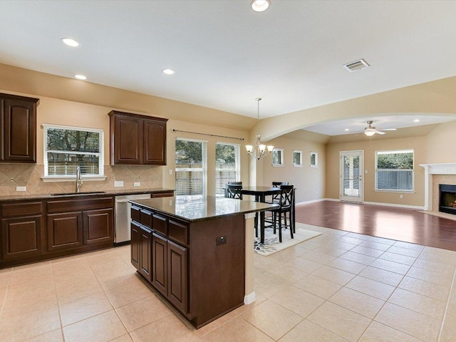 2829 Homecoming, Leander, TX 78641 - kitchen featuring a sink, stainless steel dishwasher, light tile patterned floors, open floor plan, and ceiling fan
