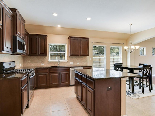 2829 Homecoming, Leander, TX 78641 - kitchen with appliances with stainless steel finishes, healthy amount of natural light, dark stone counters, and recessed lighting