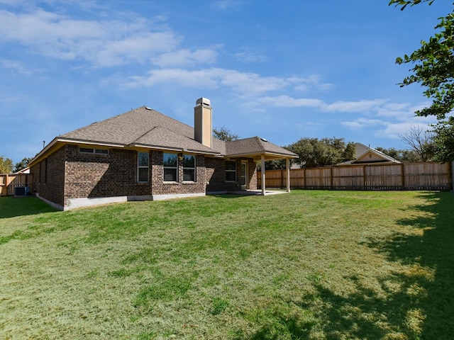 2829 Homecoming, Leander, TX 78641 - rear view of property with a fenced backyard, a chimney, brick siding, a patio area, and roof with shingles
