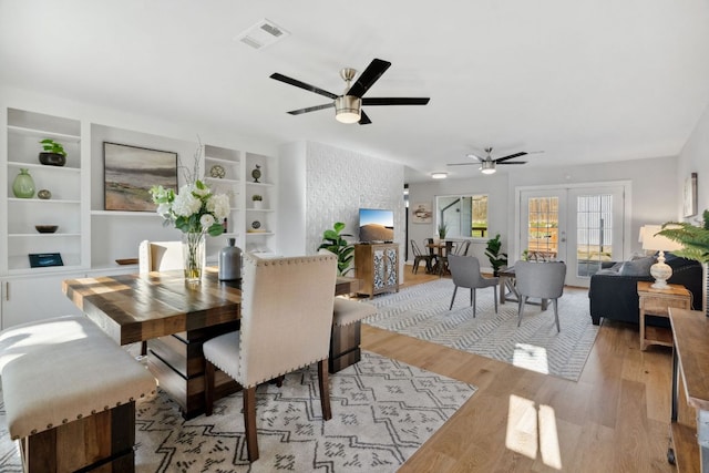 5307 Halmark Dr, Austin, TX 78723 - dining room featuring light wood-style floors, a ceiling fan, and built in shelves