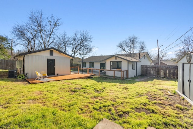 5307 Halmark Dr, Austin, TX 78723 - back of house featuring a fenced backyard, a deck, and an outbuilding