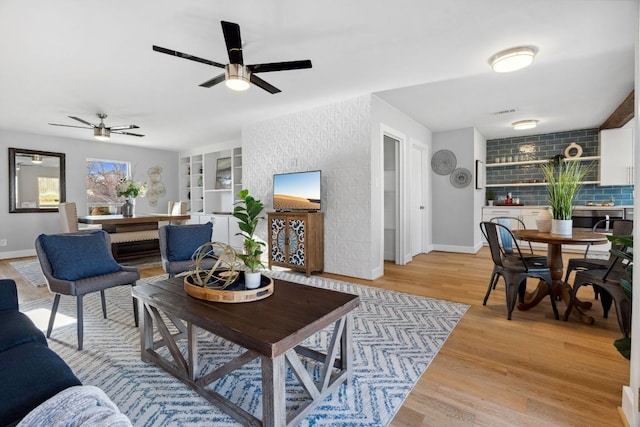 5307 Halmark Dr, Austin, TX 78723 - living room featuring a ceiling fan, light wood-style floors, and built in features