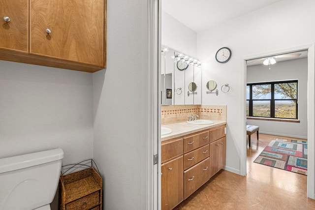 501 Hays Country Acres Rd, Dripping Springs, TX 78620 - full bath with tasteful backsplash, double vanity, toilet, ceiling fan, and baseboards