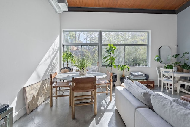 sunroom with wood ceiling and concrete flooring