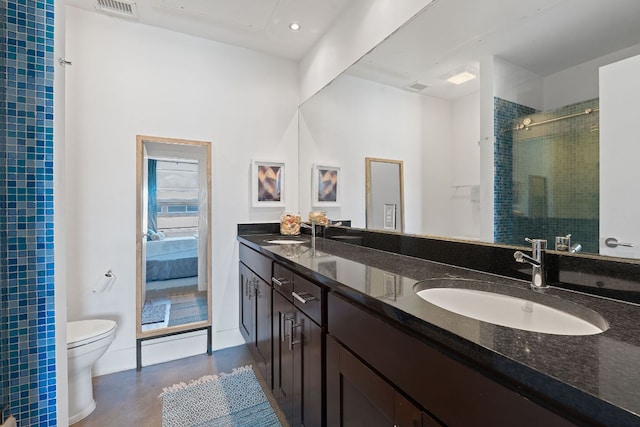 full bathroom featuring toilet, visible vents, a shower stall, and a sink