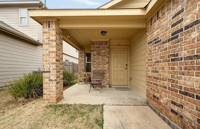 7012 Razors Edge Dr, Austin, TX 78744 - view of exterior entry with brick siding and a patio area