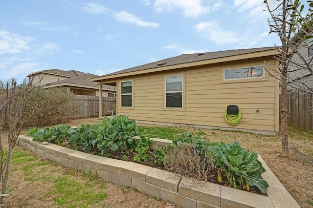 7012 Razors Edge Dr, Austin, TX 78744 - view of side of property with a vegetable garden