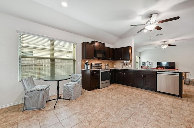 7012 Razors Edge Dr, Austin, TX 78744 - kitchen with stainless steel appliances, vaulted ceiling, a sink, ceiling fan, and dark brown cabinets