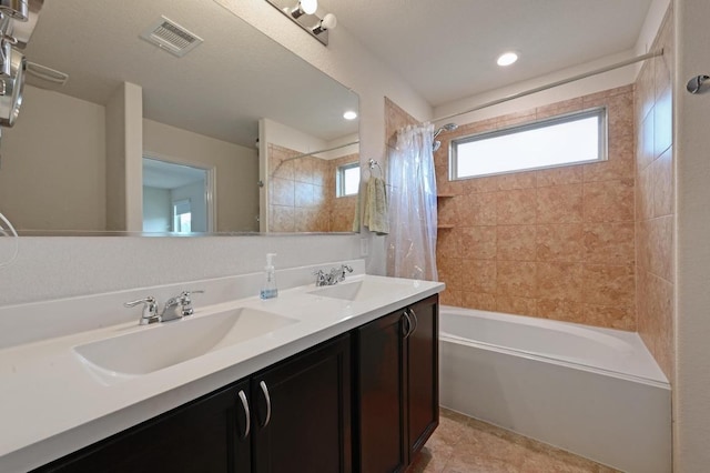 7012 Razors Edge Dr, Austin, TX 78744 - bathroom with shower / bath combo, double vanity, and recessed lighting