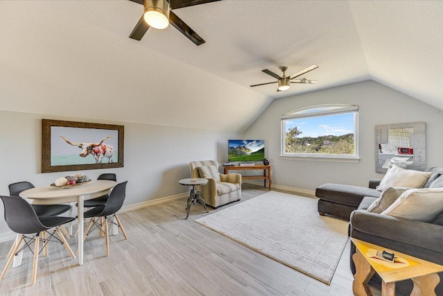 14415 Echo Blf, Austin, TX 78737 - living room featuring a ceiling fan, lofted ceiling, light wood finished floors, and a textured ceiling