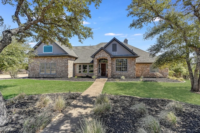 14415 Echo Blf, Austin, TX 78737 - view of front of home with stone siding, a front lawn, and a chimney