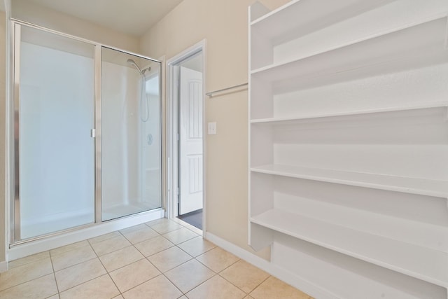 5825 Roderick Dr, Austin, TX 78724 - bathroom with a shower stall, tile patterned flooring, and baseboards