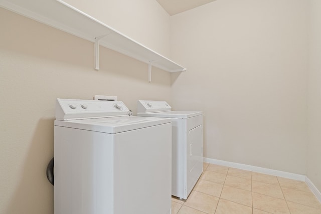 5825 Roderick Dr, Austin, TX 78724 - washroom featuring washing machine and clothes dryer, baseboards, and light tile patterned flooring