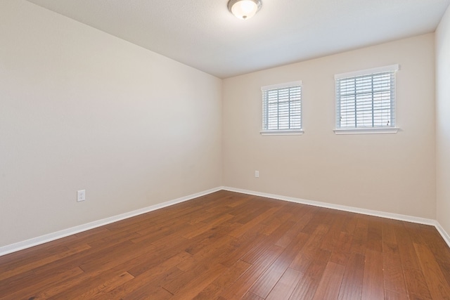 5825 Roderick Dr, Austin, TX 78724 - empty room with baseboards and dark wood finished floors