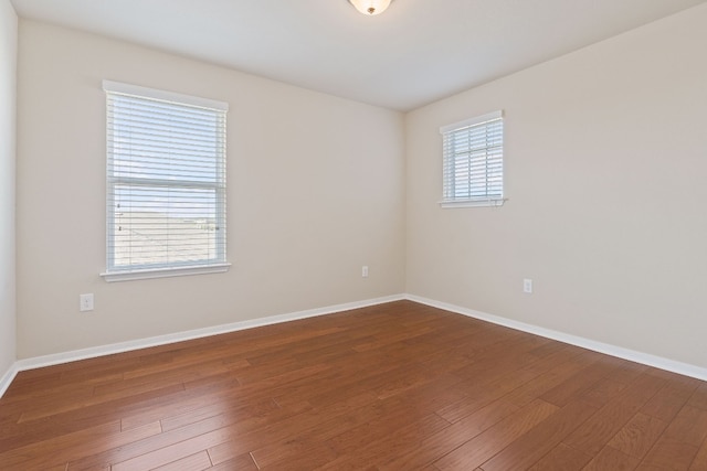 5825 Roderick Dr, Austin, TX 78724 - spare room featuring wood finished floors and baseboards