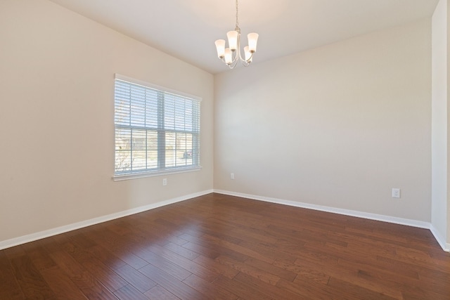 5825 Roderick Dr, Austin, TX 78724 - empty room featuring a chandelier, dark wood-style flooring, and baseboards