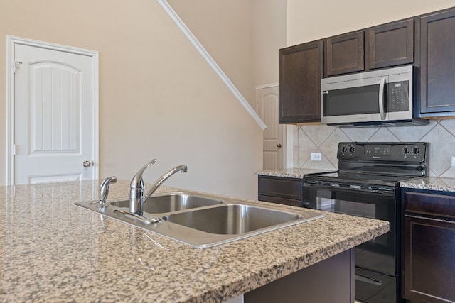 5825 Roderick Dr, Austin, TX 78724 - kitchen featuring electric range, stainless steel microwave, a sink, dark brown cabinetry, and decorative backsplash