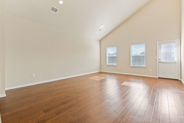 5825 Roderick Dr, Austin, TX 78724 - unfurnished living room with high vaulted ceiling, wood finished floors, and baseboards