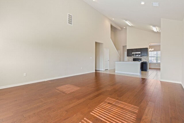 5825 Roderick Dr, Austin, TX 78724 - unfurnished living room featuring high vaulted ceiling, light wood-type flooring, baseboards, and recessed lighting