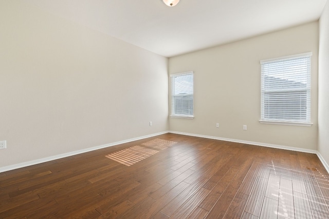 5825 Roderick Dr, Austin, TX 78724 - unfurnished room featuring baseboards and dark wood-style flooring