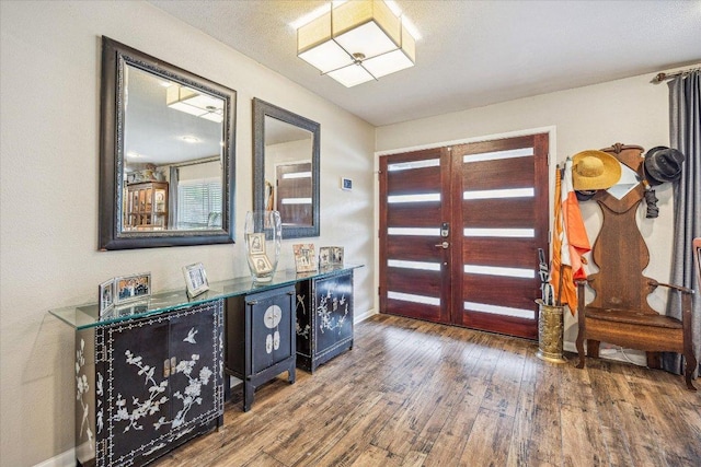 2402 Stevens Cv, Austin, TX 78723 - entrance foyer with wood finished floors, baseboards, and french doors