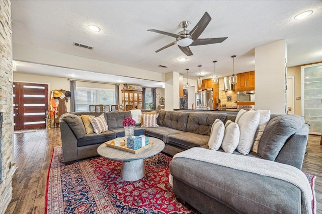 2402 Stevens Cv, Austin, TX 78723 - living room with ceiling fan, wood finished floors, recessed lighting, and a textured ceiling