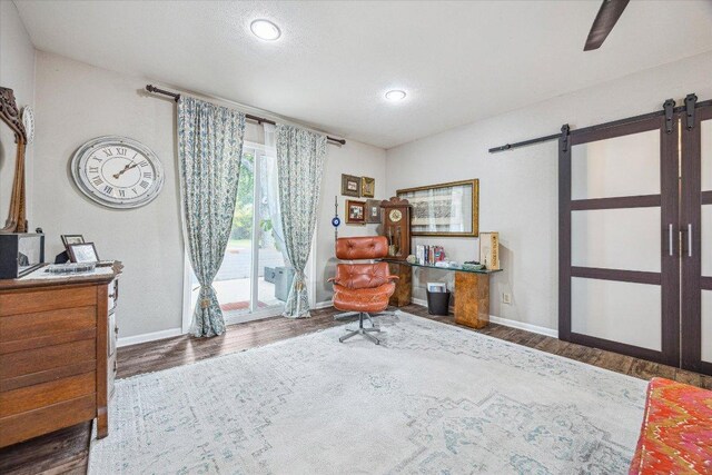 2402 Stevens Cv, Austin, TX 78723 - office area with a barn door, wood finished floors, and recessed lighting