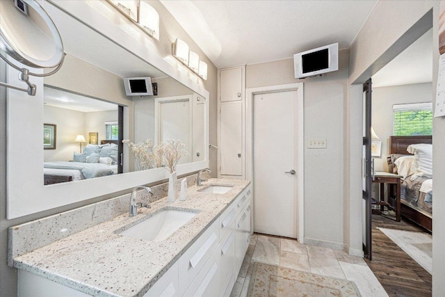 2402 Stevens Cv, Austin, TX 78723 - ensuite bathroom featuring double vanity and plenty of natural light