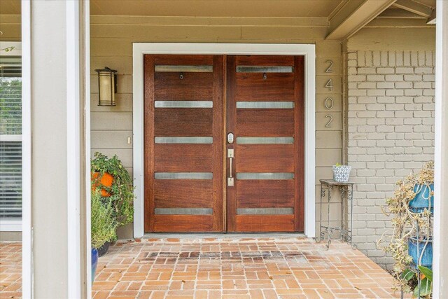 2402 Stevens Cv, Austin, TX 78723 - doorway to property featuring french doors and brick siding