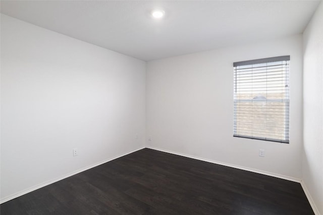 12024 Roving Pass, Elgin, TX 78621 - spare room featuring dark wood-style flooring and baseboards