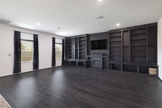 12024 Roving Pass, Elgin, TX 78621 - unfurnished living room with wood finished floors, a fireplace, recessed lighting, and built in shelves