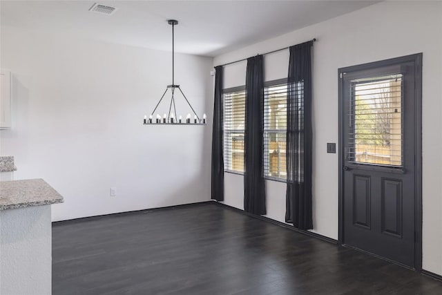 12024 Roving Pass, Elgin, TX 78621 - unfurnished dining area with a chandelier and dark wood-style flooring