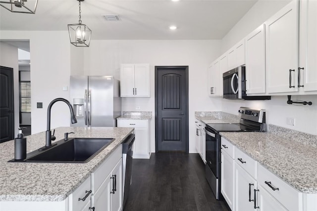 12024 Roving Pass, Elgin, TX 78621 - kitchen featuring appliances with stainless steel finishes, a sink, a kitchen island with sink, hanging light fixtures, and white cabinetry