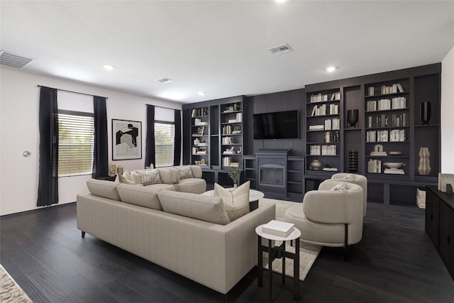 12024 Roving Pass, Elgin, TX 78621 - living room featuring dark wood finished floors, a fireplace, recessed lighting, and built in shelves