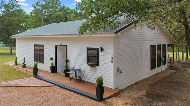 120 Lake Point Way, Bastrop, TX 78602 - rear view of house with metal roof and a deck