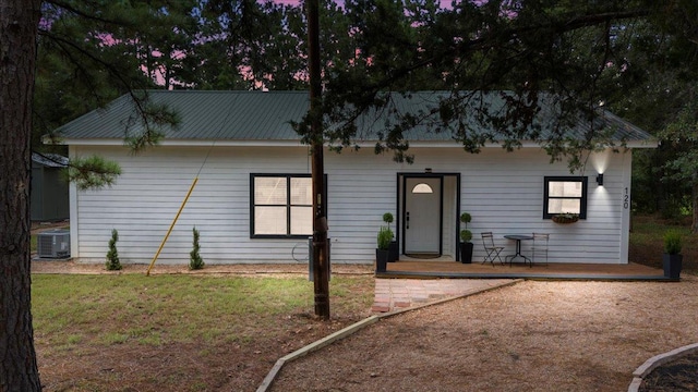 120 Lake Point Way, Bastrop, TX 78602 - view of front of house with a front yard, cooling unit, and metal roof