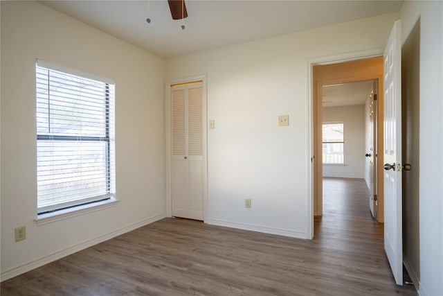 1510 Prather St, Taylor, TX 76574 - unfurnished bedroom with a closet, baseboards, and wood finished floors