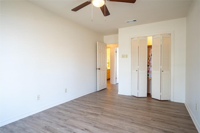 1510 Prather St, Taylor, TX 76574 - unfurnished bedroom featuring wood finished floors, visible vents, baseboards, ceiling fan, and a closet