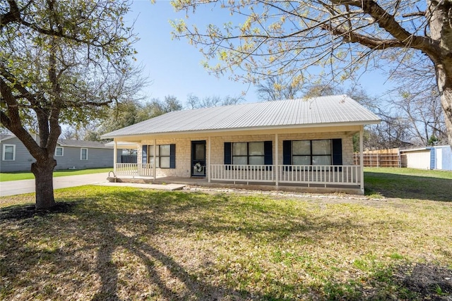 1510 Prather St, Taylor, TX 76574 - view of front of property with metal roof, a porch, a front lawn, and fence