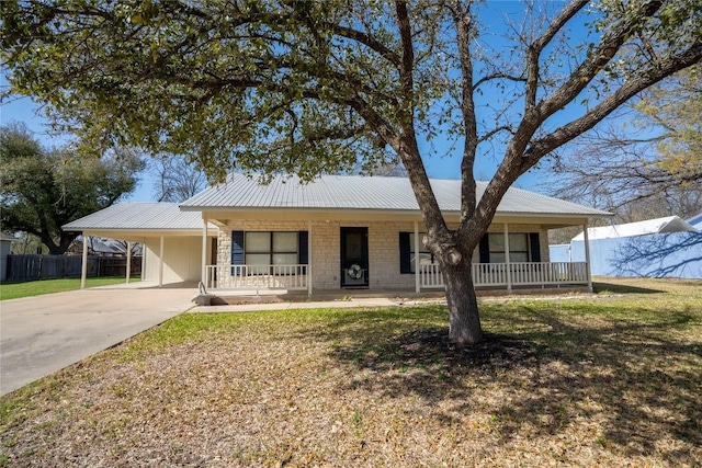 1510 Prather St, Taylor, TX 76574 - ranch-style home with an attached carport, fence, covered porch, metal roof, and driveway