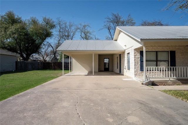 1510 Prather St, Taylor, TX 76574 - view of side of property featuring a lawn, driveway, fence, metal roof, and a carport
