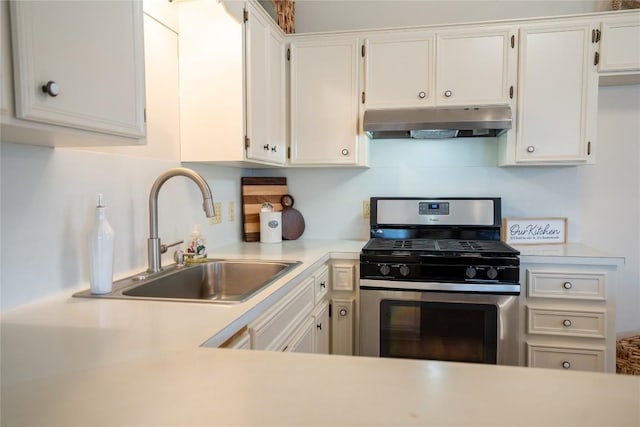 1510 Prather St, Taylor, TX 76574 - kitchen with under cabinet range hood, a sink, white cabinetry, light countertops, and stainless steel gas range