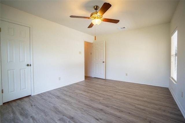 1510 Prather St, Taylor, TX 76574 - empty room with baseboards, wood finished floors, a healthy amount of sunlight, and ceiling fan