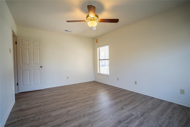 1510 Prather St, Taylor, TX 76574 - spare room with visible vents, baseboards, dark wood-type flooring, and ceiling fan