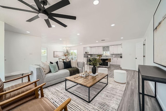 5510 Coventry Ln, Austin, TX 78723 - living area with light wood-style floors, a ceiling fan, recessed lighting, and a chandelier
