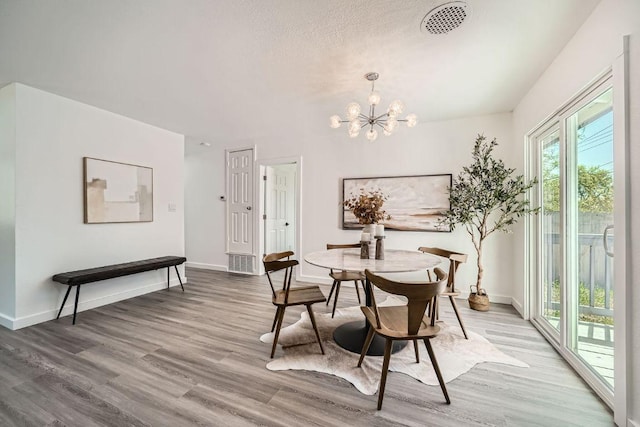 5510 Coventry Ln, Austin, TX 78723 - dining space with light wood-style floors, a chandelier, and baseboards