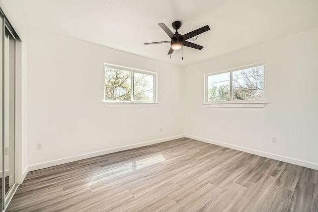 5510 Coventry Ln, Austin, TX 78723 - empty room with plenty of natural light, wood finished floors, and baseboards