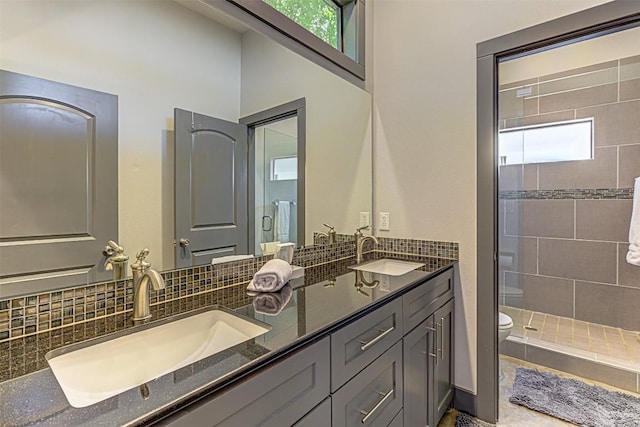 2612 Hidalgo St, Austin, TX 78702 - bathroom featuring double vanity, a stall shower, and tasteful backsplash