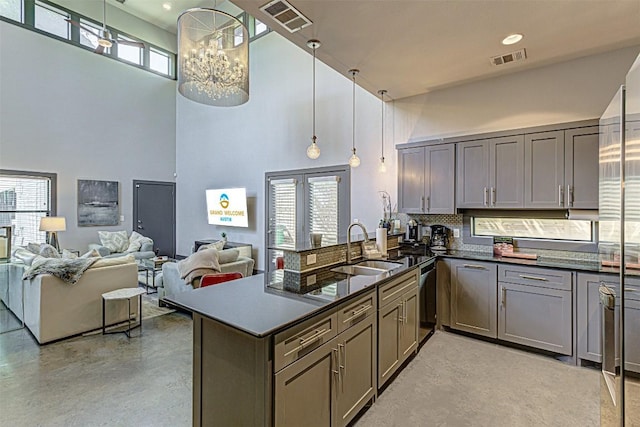 2612 Hidalgo St, Austin, TX 78702 - kitchen with a high ceiling, concrete flooring, tasteful backsplash, gray cabinets, and plenty of natural light