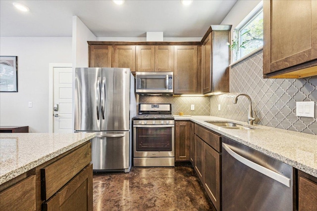 11393/4 Gunter St Unit B, Austin, TX 78721 - kitchen featuring appliances with stainless steel finishes, concrete floors, backsplash, and light stone countertops
